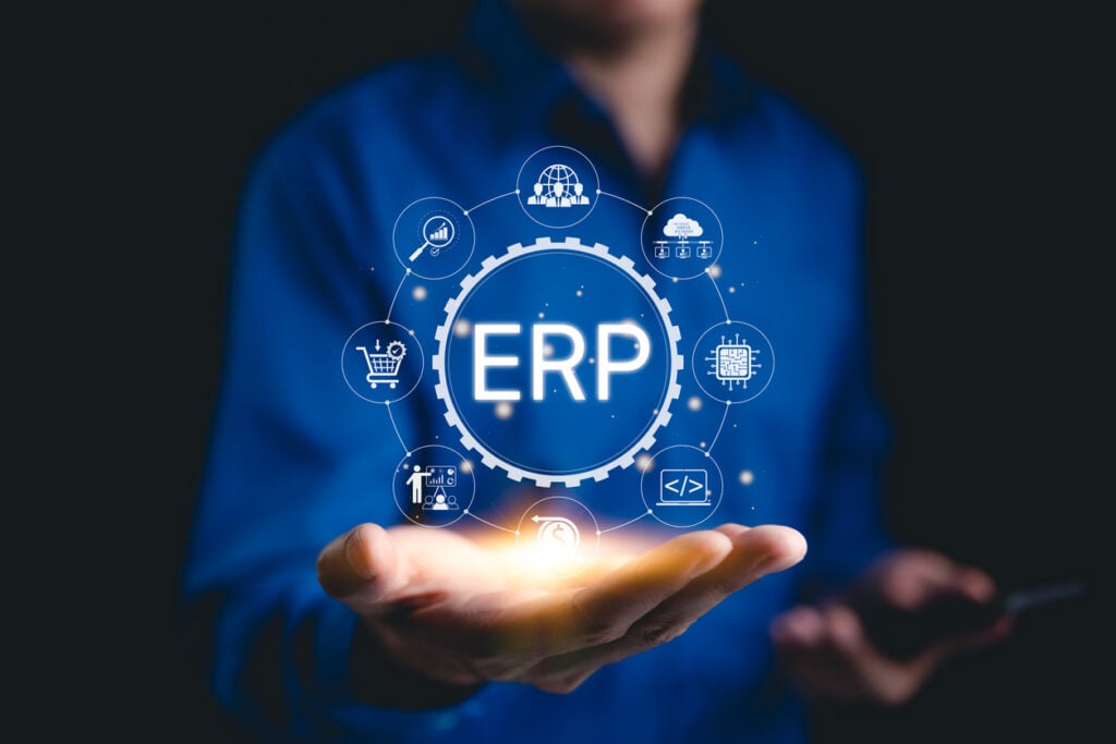 ERP - Enterprise Resource Planning, like Oracle PeopleSoft. A business professional presenting ERP system icons representing tools for Oracle PeopleSoft security, planning, architecture, threats, and patch history.